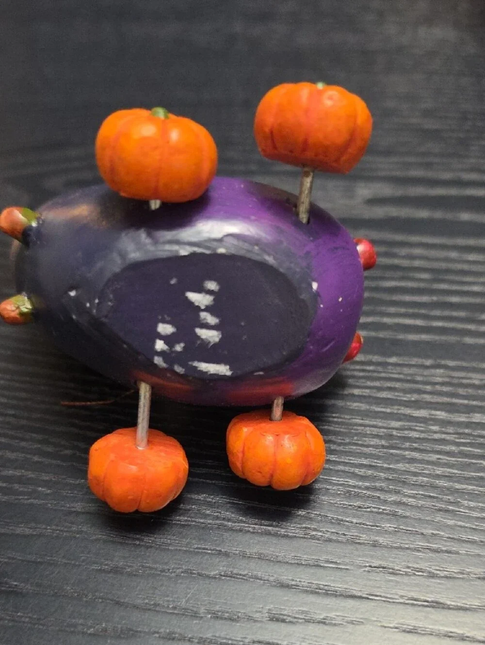 Autumn figurine of a scarecrow in a Eggplant cart
